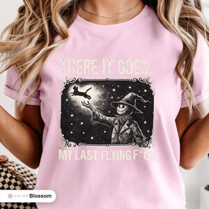 Model wearing a blossom t-shirt printed with "Last Flight Skeleton Bat" across the chest.