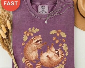 Nature's Little Mischiefs Shirt, Whimsical Creatures Tee, Playful Raccoon Top, Foliage and Acorns Design, Hand-drawn Animal Gift
