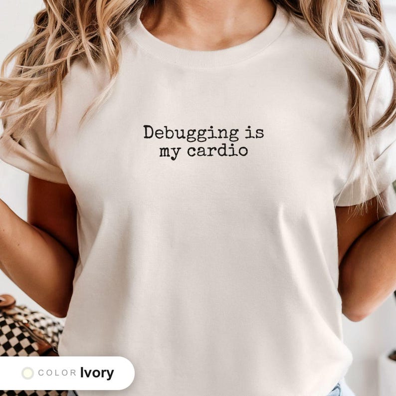 Model wearing a ivory t-shirt printed with "Debugging is my cardio" across the chest.