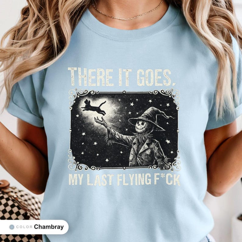 Model wearing a chambray t-shirt printed with "Last Flight Skeleton Bat" across the chest.
