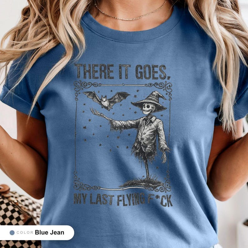 Model wearing a blue jean t-shirt printed with "Graveyard Bat Catcher" across the chest.
