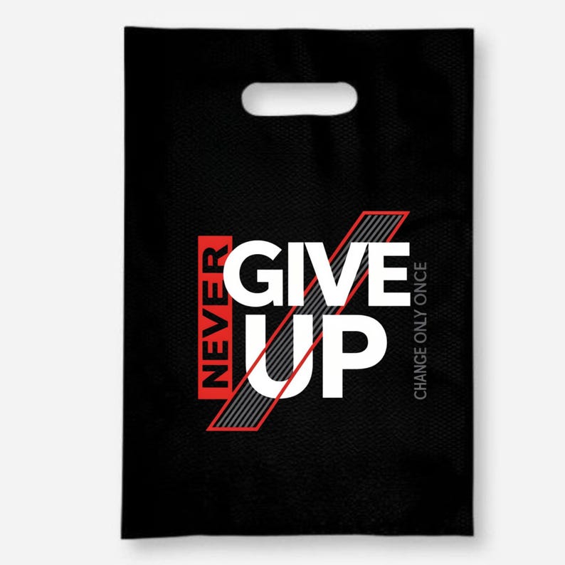 May include: Black tote bag with a die-cut handle. The bag features the words "NEVER GIVE UP" in white, red, and gray, with the phrase "CHANGE ONLY ONCE" printed vertically on the right side.