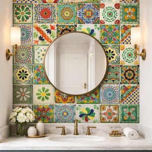 May include: A bathroom vanity with a round mirror and a backsplash of colorful patterned tiles. The vanity has a marble countertop, a white sink, and a teal cabinet. Two sconces flank the mirror, and a glass pendant light hangs above.