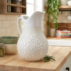 May include: A set of three ceramic mugs with a speckled, matte finish. The mugs are in shades of cream, light gray, and dark gray. Each mug has a simple, minimalist design, suitable for coffee or tea.