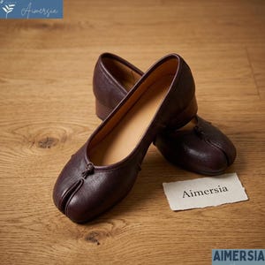 May include: A set of three ceramic mugs with a speckled, matte finish. The mugs are in shades of cream, light gray, and dark gray. Each mug has a simple, minimalist design and a rounded handle.