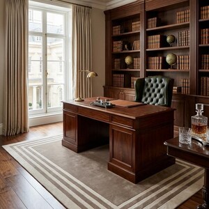 May include: A dark wood executive desk with a leather inlay, paired with a tufted dark green leather armchair. The room features floor-to-ceiling wooden bookshelves filled with books and globes, a brass desk lamp, and a rectangular area rug.