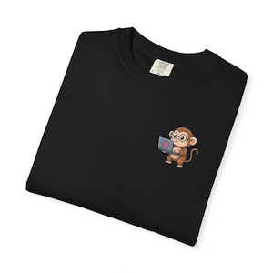 May include: Black crew neck t-shirt with a small embroidered graphic of a cartoon monkey wearing glasses and holding a laptop displaying a brain. The shirt has a tag that says "Comfort Colors".