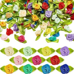 May include: A collection of colorful ribbon roses with green leaves. The roses are in various shades of red, yellow, pink, purple, and blue. These decorative flowers are ideal for crafting and embellishments.