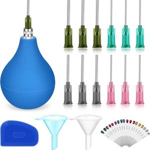 May include: A blue rubber bulb syringe with a metal tip, twelve assorted colored needle tips, a blue plastic scraper, two clear plastic funnels, and a fan-shaped display card featuring numerous small, colorful, metallic-finished nail tips.