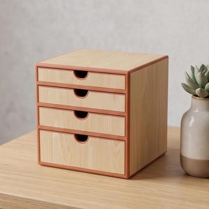 May include: A square desktop storage unit featuring four horizontal drawers with a light wood grain finish and a solid terracotta orange frame. Each drawer has a semi-circular cutout handle for easy access, creating a clean and organized look.