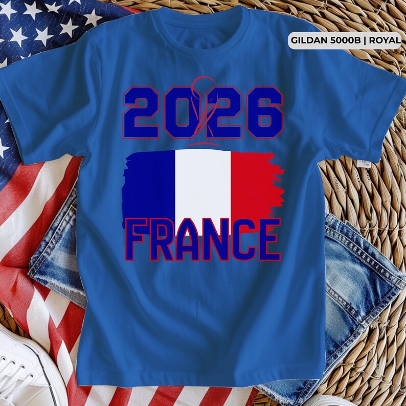 May include: Royal blue t-shirt with the text "2026" in blue and red. Below the text is a stylized French flag with the word "FRANCE" in red. The shirt is made of Gildan 5000B material.