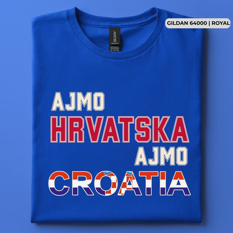May include: A royal blue short-sleeve t-shirt featuring the text AJMO HRVATSKA AJMO CROATIA in white and red block lettering. The word CROATIA incorporates a red and white checkered pattern within its letters. A Gildan 64000 label is visible.
