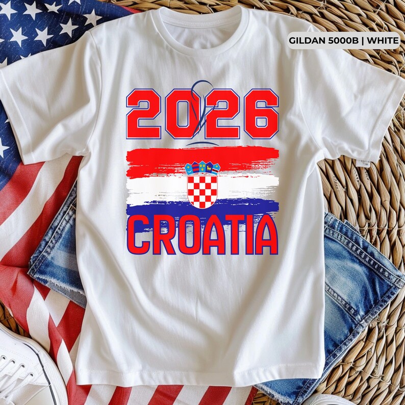 May include: White t-shirt with the text "2026 CROATIA" in red and blue. The design includes a Croatian flag graphic. The shirt is made of white fabric and is likely a souvenir or fan apparel.