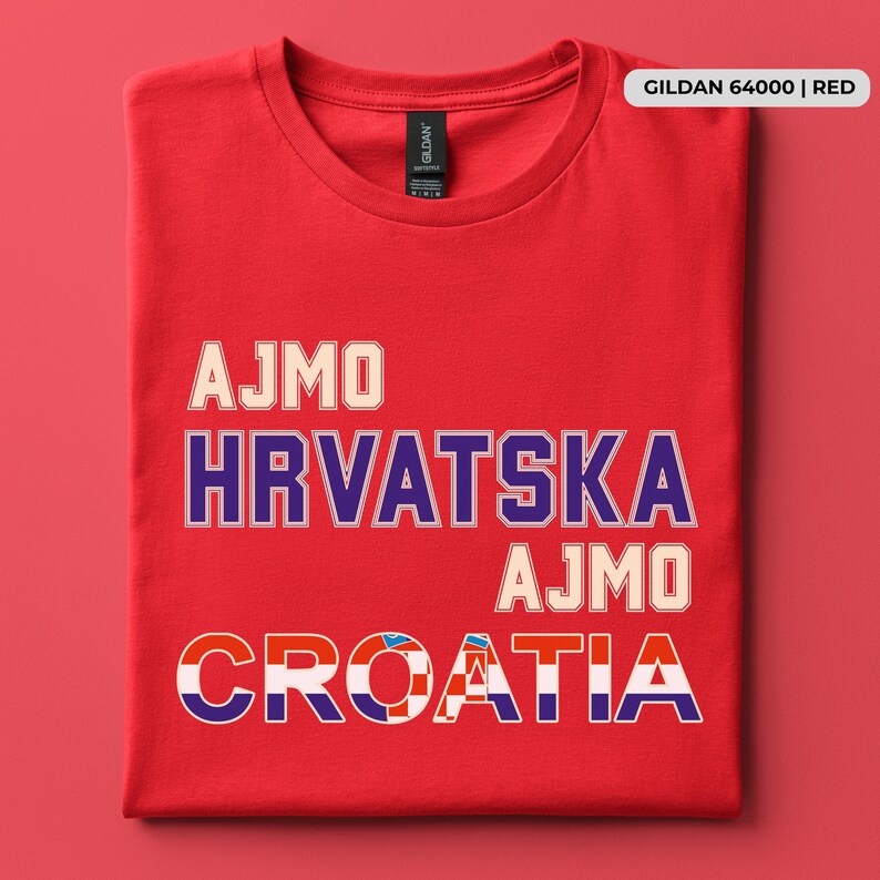 May include: A red short-sleeved t-shirt featuring the text AJMO, HRVATSKA, AJMO, and CROATIA printed in a bold, block-style font. The word CROATIA incorporates a red and white checkered pattern within the letters. A label reads GILDAN 64000 | RED.