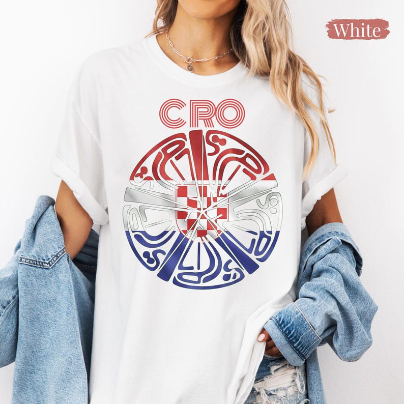 May include: A white short-sleeved t-shirt featuring a circular graphic design with the text CRO at the top. The graphic incorporates the red, white, and blue colors of the Croatian flag with a central red and white checkered shield emblem.