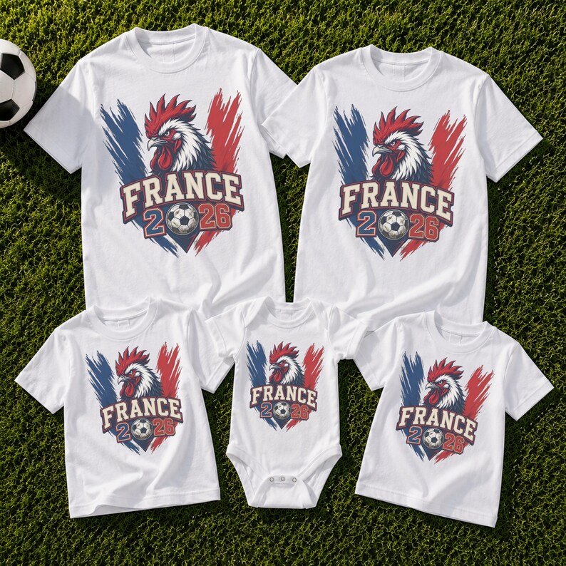 May include: White t-shirts and a onesie with a graphic featuring a rooster, the text "FRANCE 2026", and a soccer ball. The design includes blue and red brushstrokes, resembling the French flag.