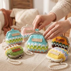 May include: A collection of colorful, handmade crochet coin purses. Each purse features a metal clasp and a pearl beaded strap. The purses are in various colors, including blue, pink, yellow, green, and orange, with "Hand Made" tags.