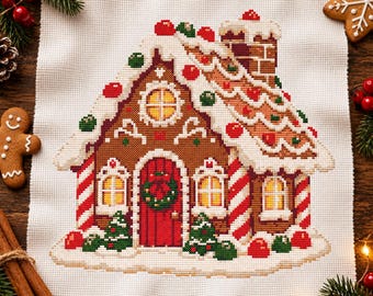 May include: A cross-stitch embroidery on white fabric depicting a gingerbread house with a brown structure, white icing roof, red and green candy accents, a red door with a wreath, and candy cane pillars, surrounded by festive holiday decor.