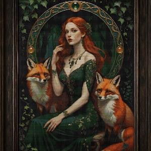 May include: A framed artwork featuring a woman with long red hair and a green dress, flanked by two foxes. The artwork has a dark, detailed background and a decorative green and gold circular element behind the woman. The frame is dark brown.