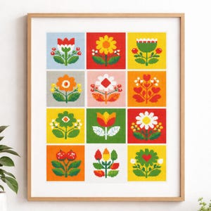 May include: A framed print featuring a grid of colorful floral designs. Each square showcases a different stylized flower in vibrant hues of red, yellow, green, and orange. The artwork is framed in a light-colored wooden frame, suitable for home decor.