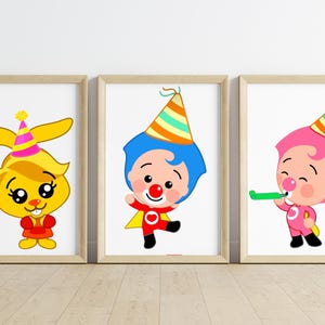 May include: Three framed prints featuring cartoon characters. The first print shows a yellow bunny wearing a party hat. The second print shows a cartoon clown with a red nose and a party hat. The third print shows a cartoon character blowing a party horn.