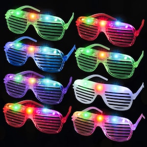 May include: A collection of eight shutter-style sunglasses featuring translucent frames in various colors including green, red, blue, purple, and white. Each pair of glasses is illuminated by small, bright LED lights that glow in multiple colors.