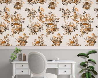 May include: A white desk and chair set against a wall with a repeating floral and mushroom wallpaper pattern. The wallpaper features brown, orange, and cream tones. A potted plant and decorative items sit on the desk.