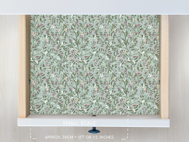 May include: A drawer liner with a small-scale floral pattern in shades of green, pink, and white. The liner is approximately 1 foot or 12 inches wide. "SMALL SCALE" and "APPROX 30CM = 1FT OR 12 INCHES" are printed on the liner.