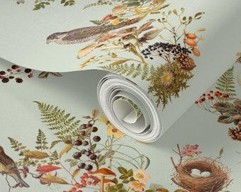 May include: A roll of wallpaper featuring a vintage botanical design. The pattern includes illustrations of birds, nests, berries, mushrooms, and various plants in shades of brown, green, orange, and yellow on a light blue background.