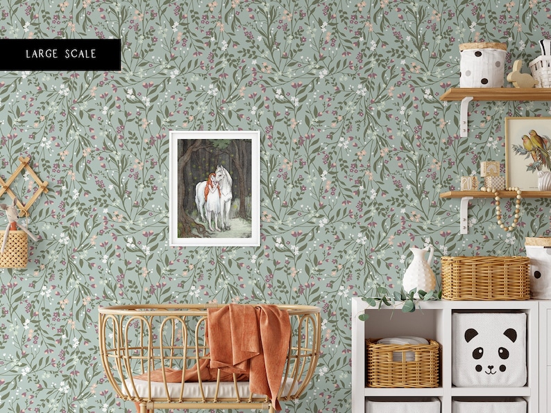 May include: A nursery room with a green floral wallpaper featuring a framed illustration of a girl and a white horse in a forest. The room also features a wicker crib with a burnt orange blanket, a white shelf with wicker baskets and a white panda-shaped storage box, and a white shelf with a white pitcher and a wicker basket.