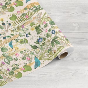 May include: A roll of wrapping paper with a white background and a repeating pattern of green leaves, pink and blue flowers, butterflies, and bees.