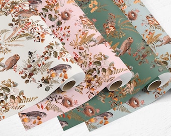 May include: Four rolls of wrapping paper with a woodland theme. The paper features a repeating pattern of owls, birds, ferns, and berries on a white, pink, green, and blue background.