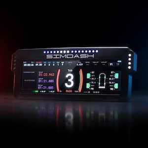 May include: A black rectangular SIMDASH racing telemetry display unit featuring a digital screen with white, red, and green data readouts. The screen displays gear number 3, tire temperatures, fuel levels, and lap times, with a row of LED lights on top.