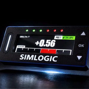 May include: A black and blue Simlogic Delta T device with a digital display showing a time difference of +0.56. The display has green and red indicator lights and the text "POS 7 26 LAPS".
