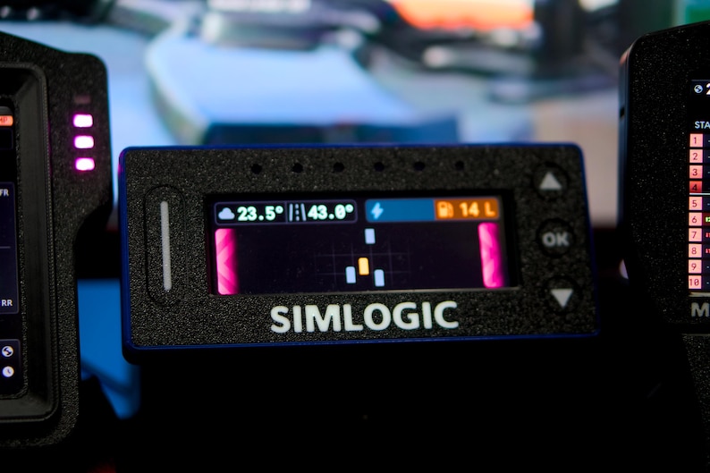 May include: A rectangular black Simlogic digital display unit featuring a textured casing and a central screen showing telemetry data including temperature, track conditions, and fuel levels at 14 L, with navigation buttons on the right side.