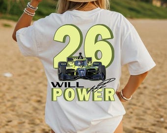 May include: A white short-sleeve t-shirt featuring a large light yellow number 26 on the back. Below the number is a graphic of a yellow and black race car, followed by the text WILL POWER in bold yellow letters with a black signature graphic.