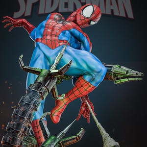 May include: A dynamic statue of Spider-Man in a classic pose, clad in a red and blue suit with web-shooters. The figure is set against a dark background, with the words "Spider-Man" prominently displayed. The statue is detailed and appears to be a collectible item.