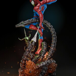 May include: A dynamic statue of Spider-Man in a classic red and blue suit, posed mid-action. He is entangled with mechanical tentacles and a green figure. The base features fiery orange and metallic elements, with the ZSZ logo in the top corner.