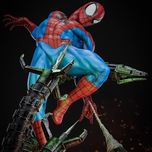May include: A detailed statue of Spider-Man in a dynamic pose, clad in his iconic red and blue suit. The figure is perched atop mechanical arms, with a web strand extending. The statue features intricate detailing and a dramatic, action-oriented design.