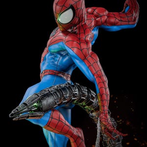 May include: A detailed statue of Spider-Man in a dynamic pose, featuring his iconic red and blue suit with web detailing. The figure has a muscular build and is holding a mechanical arm with green accents. The background is black.