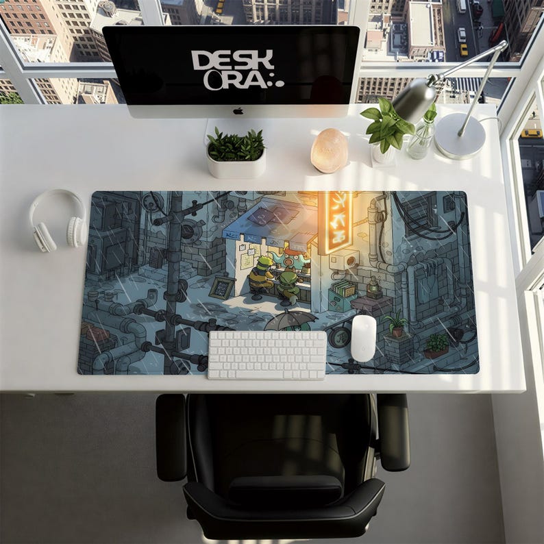 May include: A computer desk setup featuring a large mousepad with a detailed illustration of a street scene with cartoon characters. The desk also includes a computer monitor with the text "DESK ORA:.", a keyboard, mouse, and headphones.