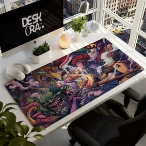 May include: A rectangular desk mat with a vibrant illustration of cartoon characters in a fantasy scene. The mat has a black border. The text "DESK ORA:" is visible on a computer screen in the background. The mat is on a white desk.