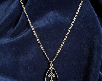 Bold black teardrop pendant with stylized cross, stainless steel chain, modern gothic edge, durable and hypoallergenic accessory