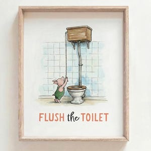 May include: A framed wall art print featuring a watercolor illustration of a small pig in green overalls pulling the chain of a vintage toilet. The background shows light blue tiled walls. The text FLUSH the TOILET is printed in orange.