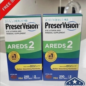 May include: Two identical rectangular boxes of PreserVision AREDS 2 eye vitamin and mineral supplement. Each blue and green box features the text Doctor #1 Recommended Brand, Now with OCUSorb, 210 Mini Soft Gels, and 2 Per Day.