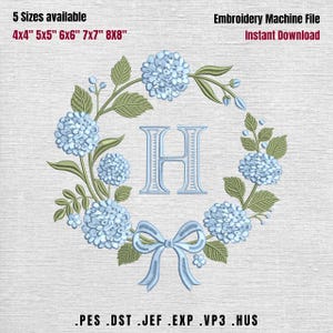 May include: An embroidery machine file featuring a floral wreath design with the letter "H" in the center. The wreath includes light blue hydrangea flowers, green leaves, and a bow. Available in 5 sizes: 4x4", 5x5", 6x6", 7x7", and 8x8".
