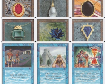 May include: A collection of nine Magic: The Gathering trading cards arranged in a grid. The top two rows feature jewelry-themed Mox cards and a Black Lotus. The bottom row displays blue-bordered cards titled Time Walk, Ancestral Recall, and Timetwister.