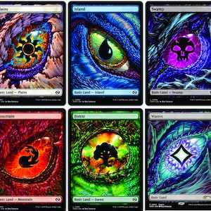 May include: Six Magic: The Gathering basic land cards. Each card features a stylized eye design with a different color scheme and symbol. The cards are labeled "Plains", "Island", "Swamp", "Mountain", "Forest", and "Wastes".