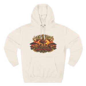 May include: A cream-colored hooded sweatshirt featuring a graphic print with the text "I AM MY ANCESTORS WILDEST DREAMS," "THEIR PRAYERS, THEIR SACRIFICES," and "MY PURPOSE. OUR LEGACY." The design includes silhouettes of people, trees, and a sun.