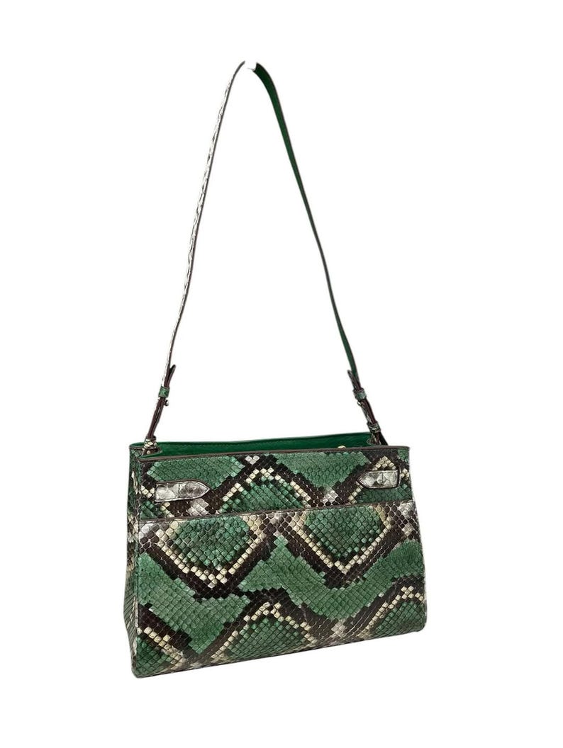 May include: A green and black snakeskin-effect shoulder bag with a long strap. The bag has a rectangular shape with a flap closure and silver-toned hardware. The interior lining is a solid green colour.
